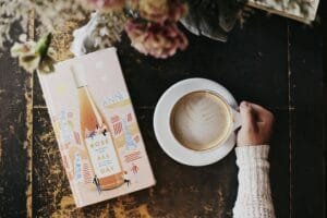 A cozy morning setting with a latte and a book, perfect for relaxation and enjoyment.