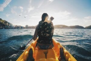 Experience the thrill of kayaking in Arraial do Cabo, Brazil with the sunlit waves and clear skies.