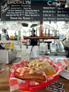 Delicious lobster roll served with chips at a bar counter in Red Hook restaurant, Brooklyn.